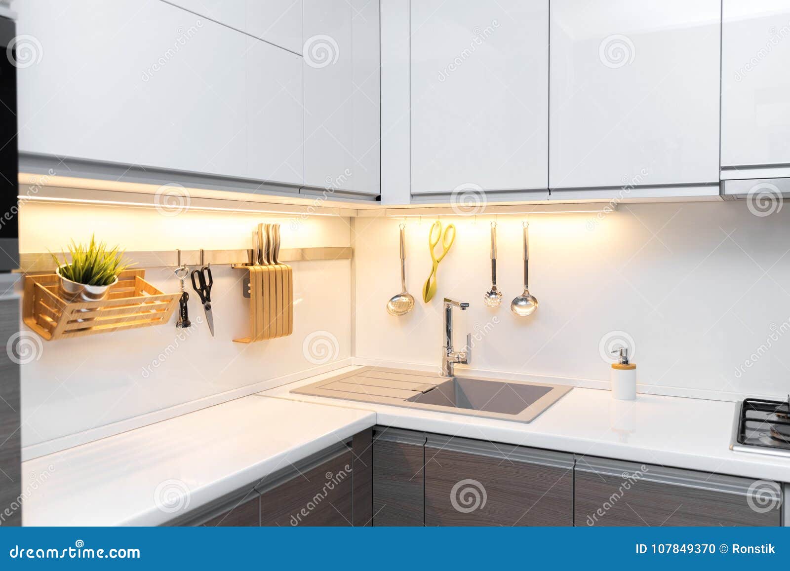 White Gloss Kitchen Interior with Worktop Lighting Stock Photo Image