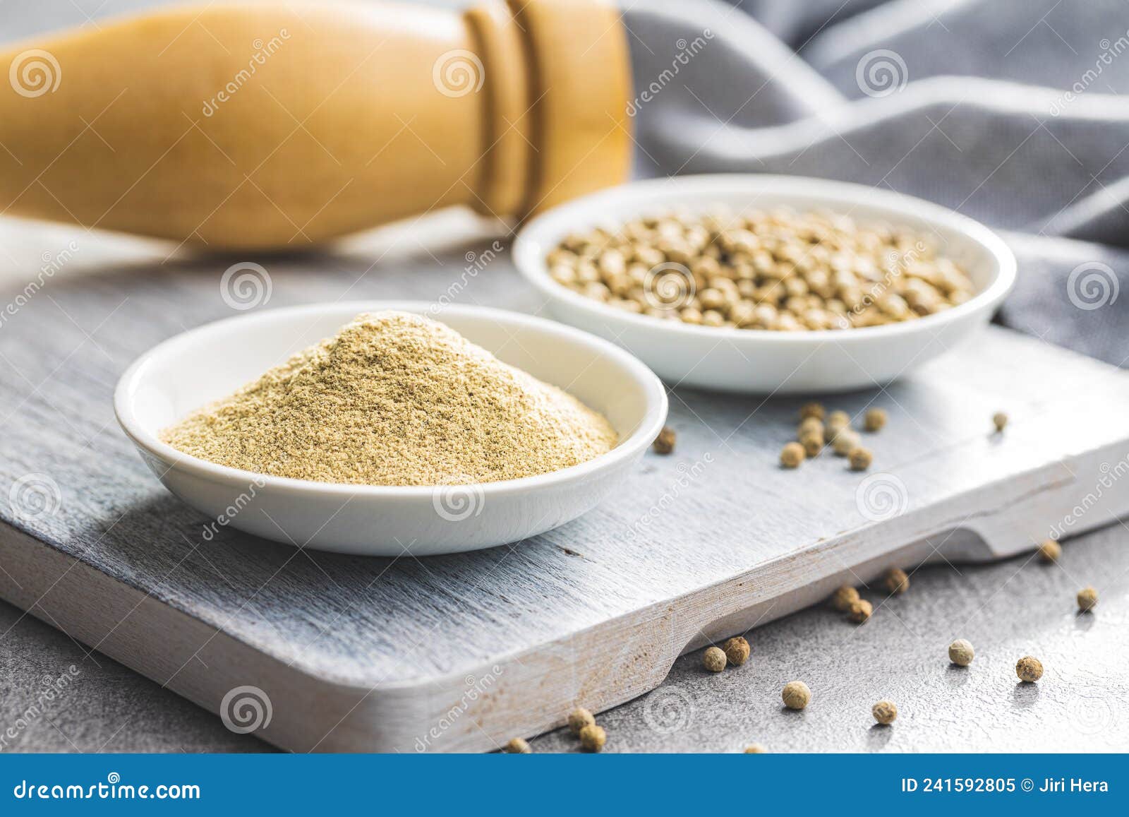 White Ground Pepper and Whole Peppercorn Spice in Bowl Stock Image
