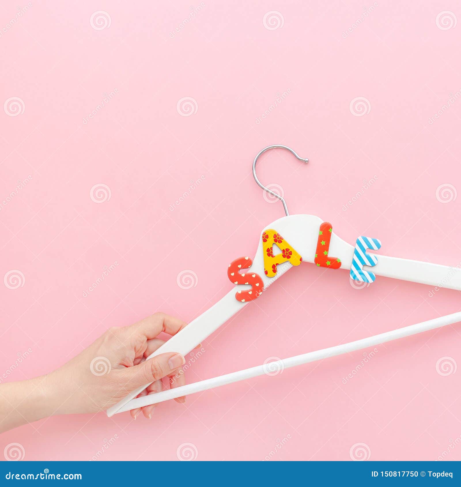 white hangers with sale text on pink background