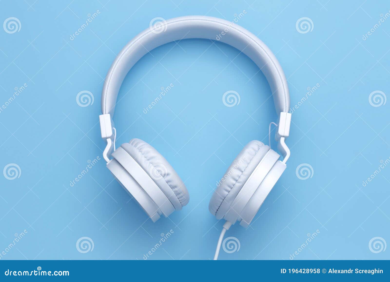 White Headphone on Blue Background. Music Concept. Stock Photo Image