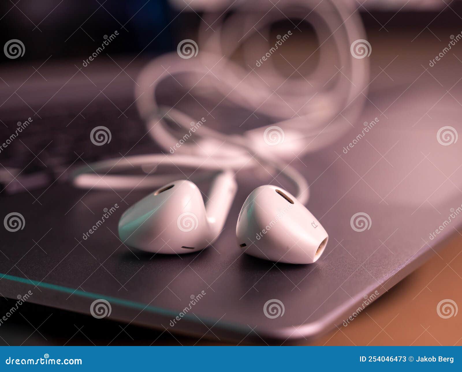 White Headphones with a Cable on a Laptop. Stock Image Image of sound
