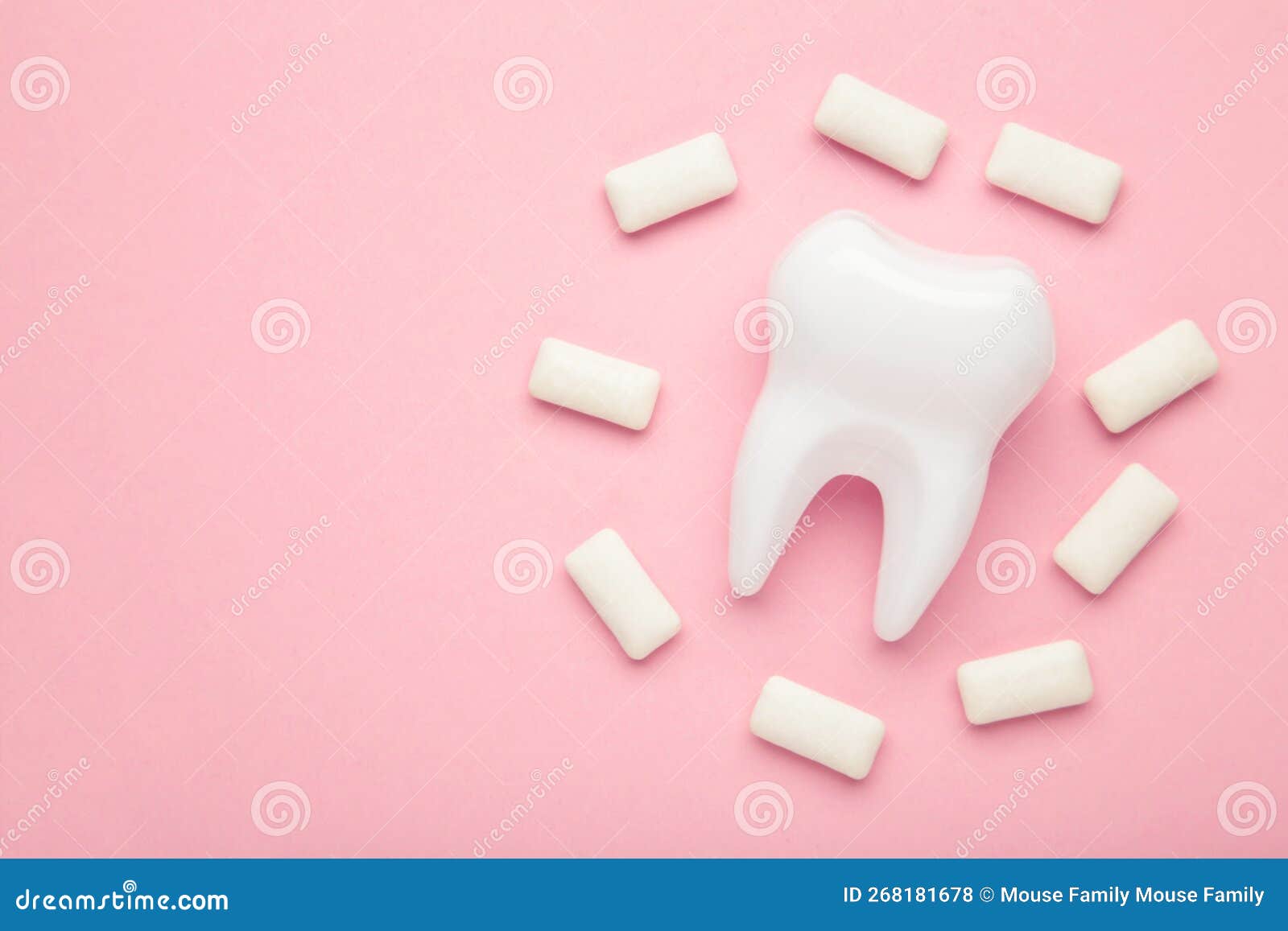 White Healthy Tooth Model And Heap Of Chewing Gums On Pink Background