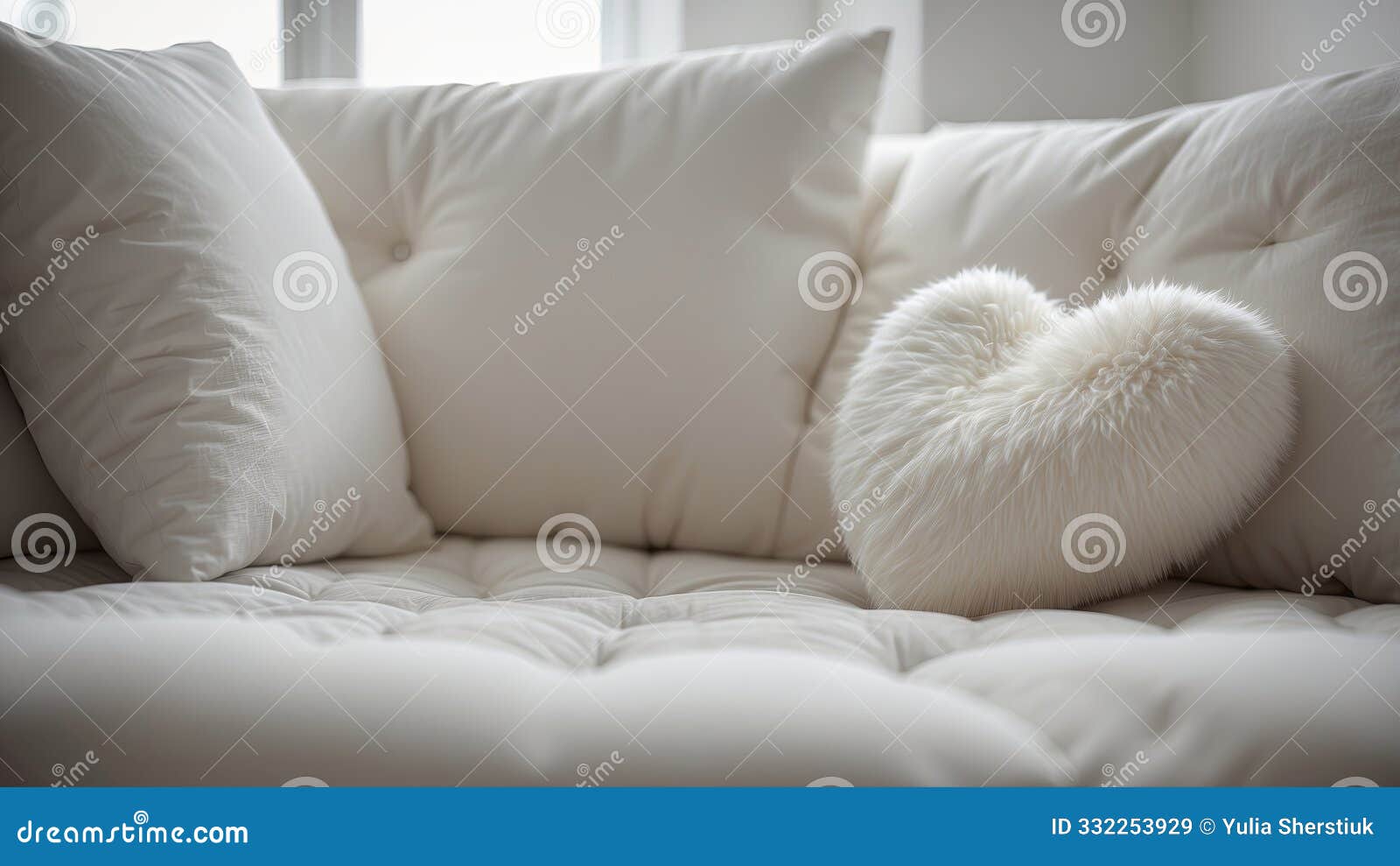 white heart-d fluffy pillow on white tufted sofa.