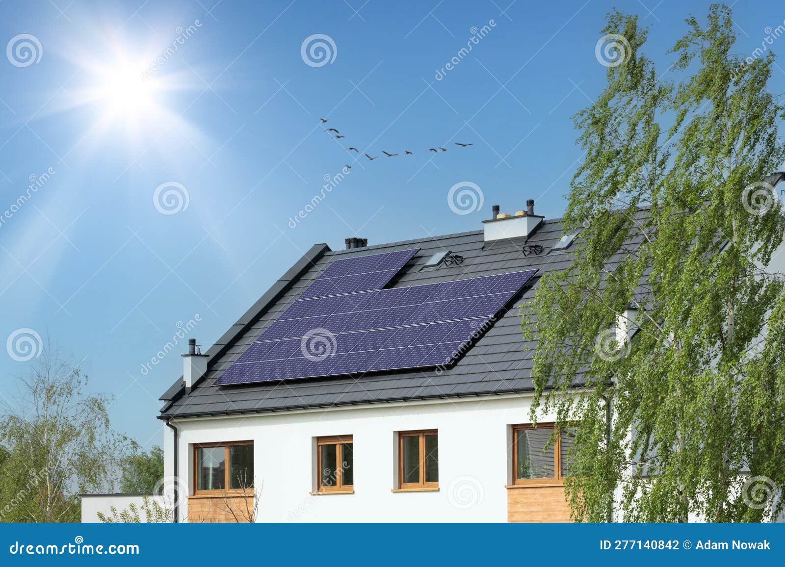 White House with Solar Panels, Sun and Cloudless Sky Stock Photo