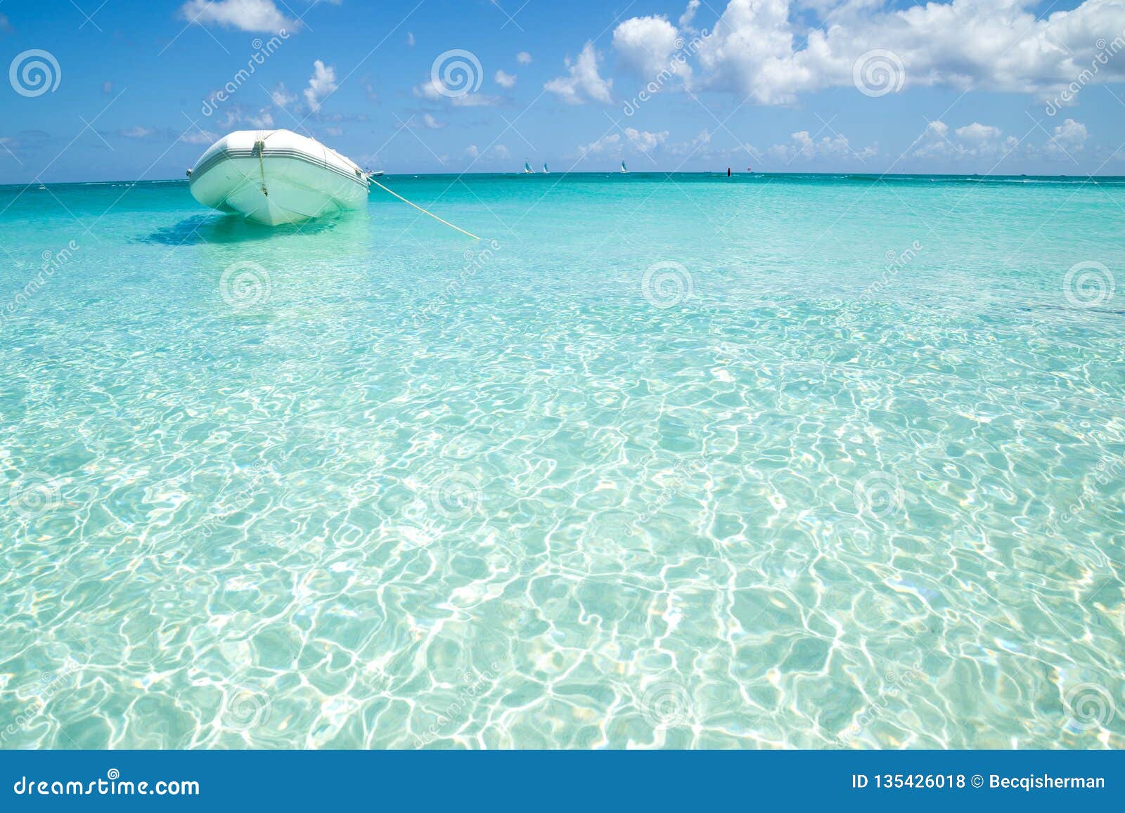 White Inflatable Boat in Turquoise Blue Caribbean Shallow Tropical