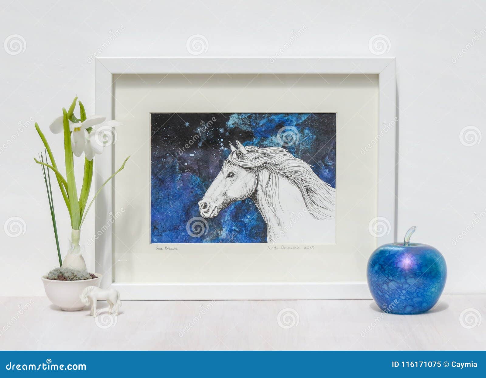 white interior display. framed horses head painting, blue background.