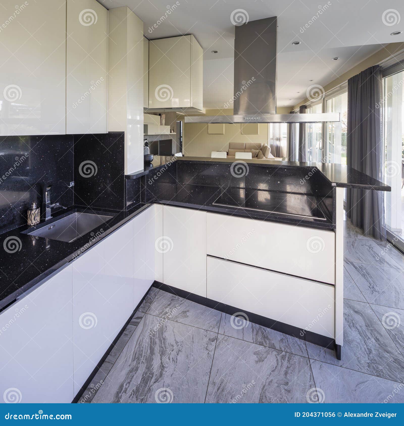 White Kitchen with Black Marble Top and Large Hood Stock Photo Image