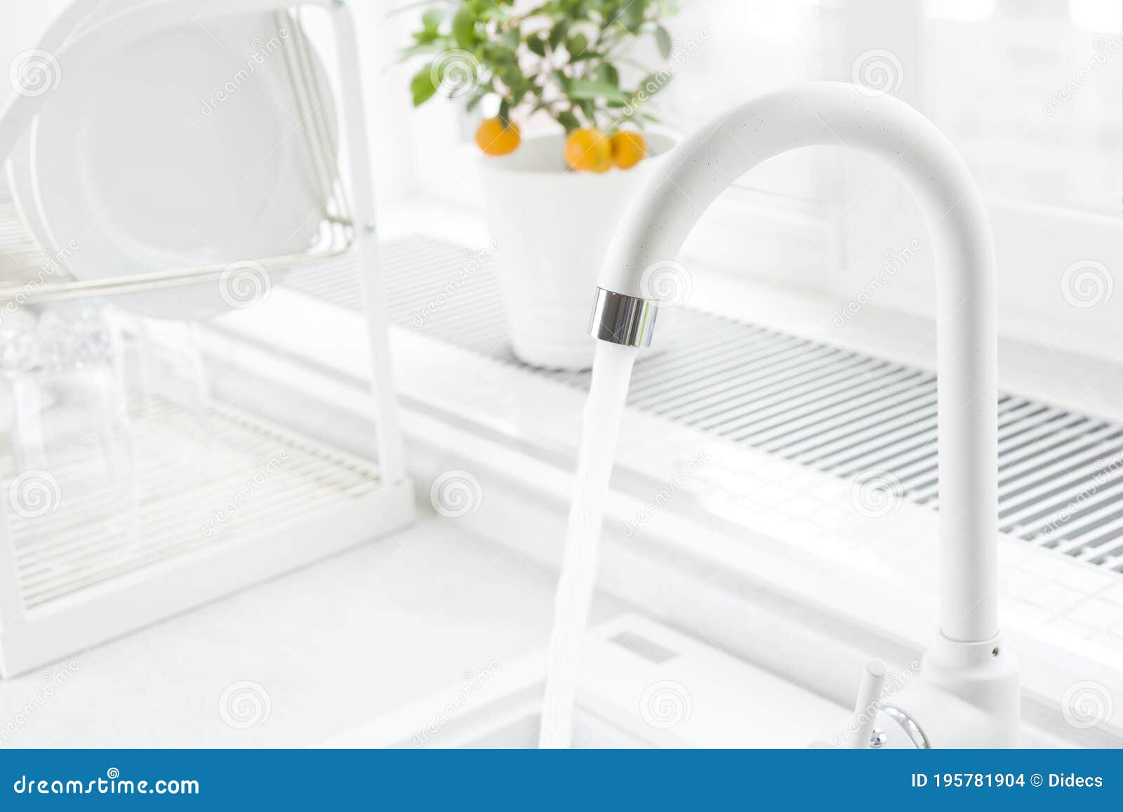 White Kitchen Faucet Running with Blurred Windowsill and Dish Dryer Stock Photo Image of steel