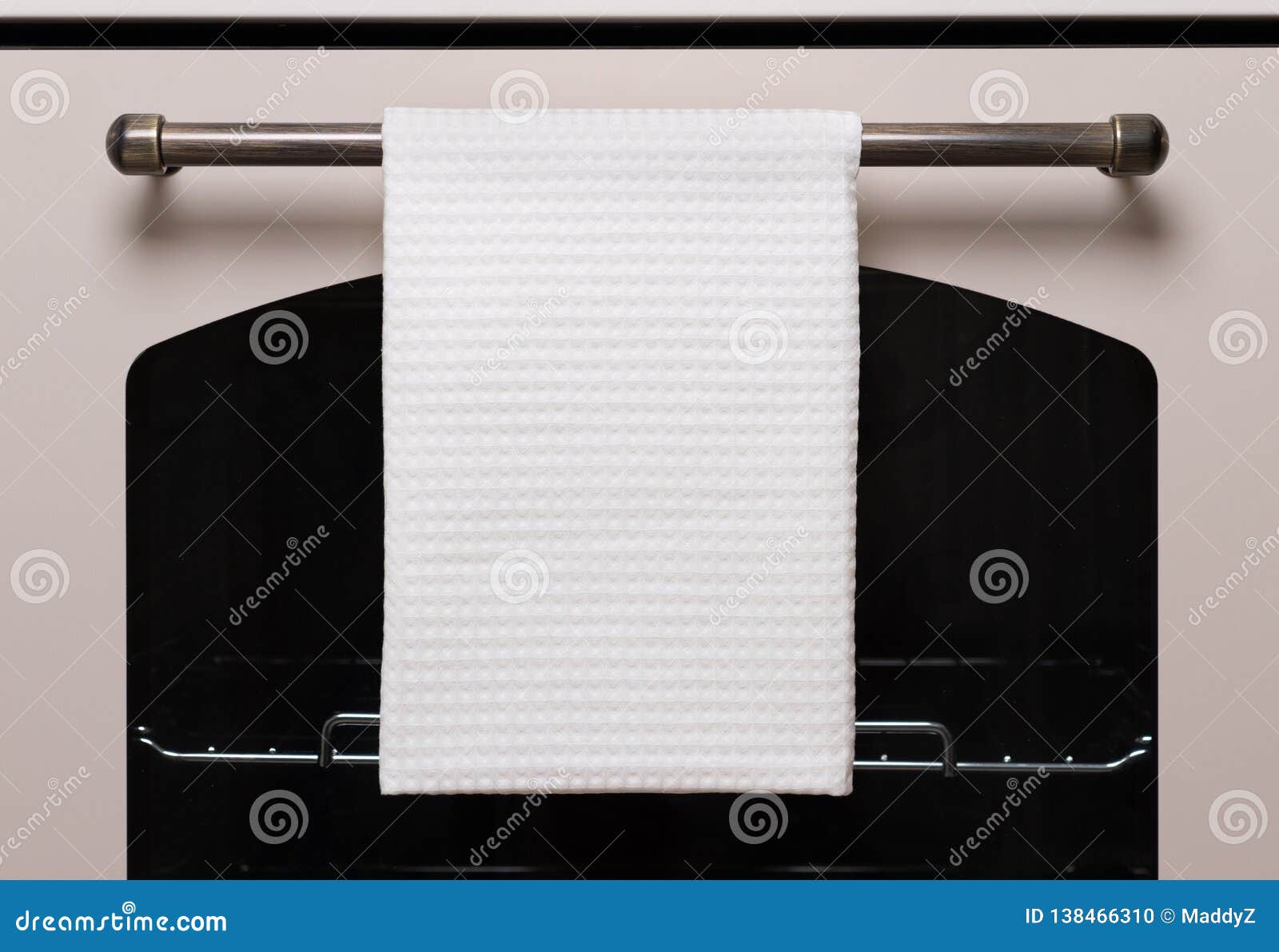 white kitchen towel hangs on the oven handle, product mockup