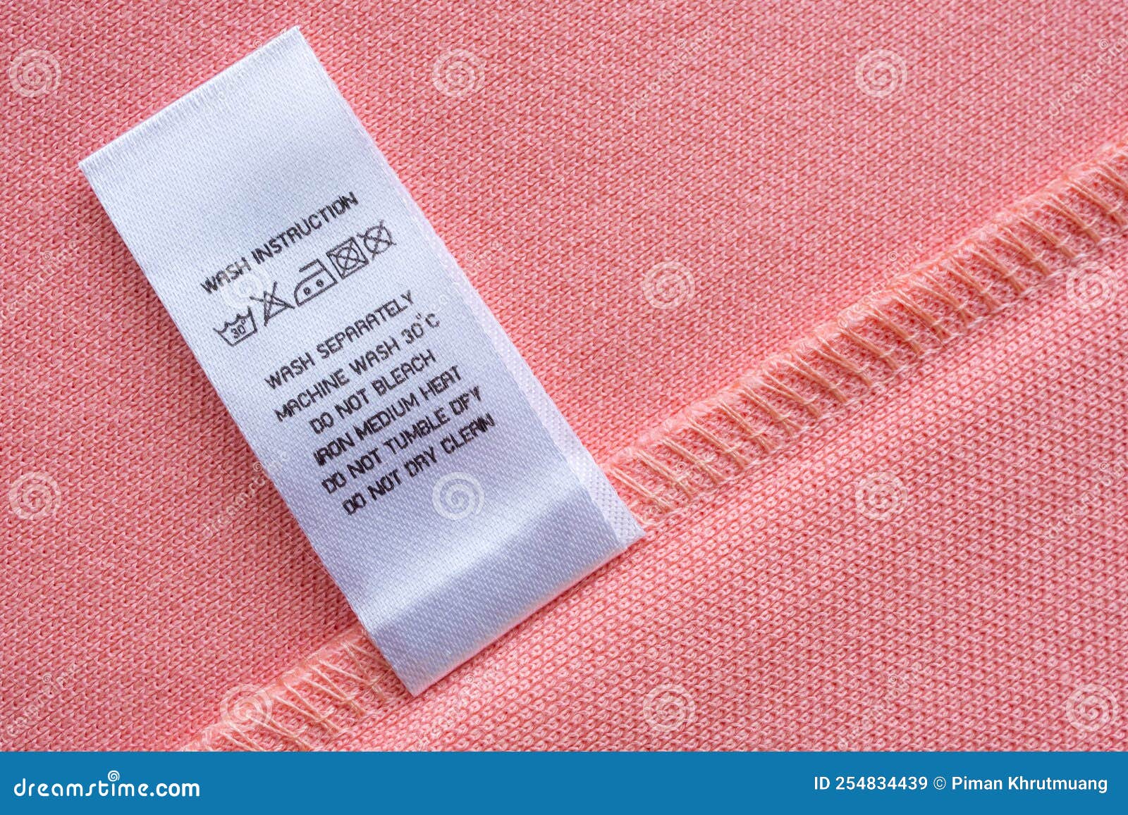 White Laundry Care Washing Instructions Clothes Label on Pink Cotton ...