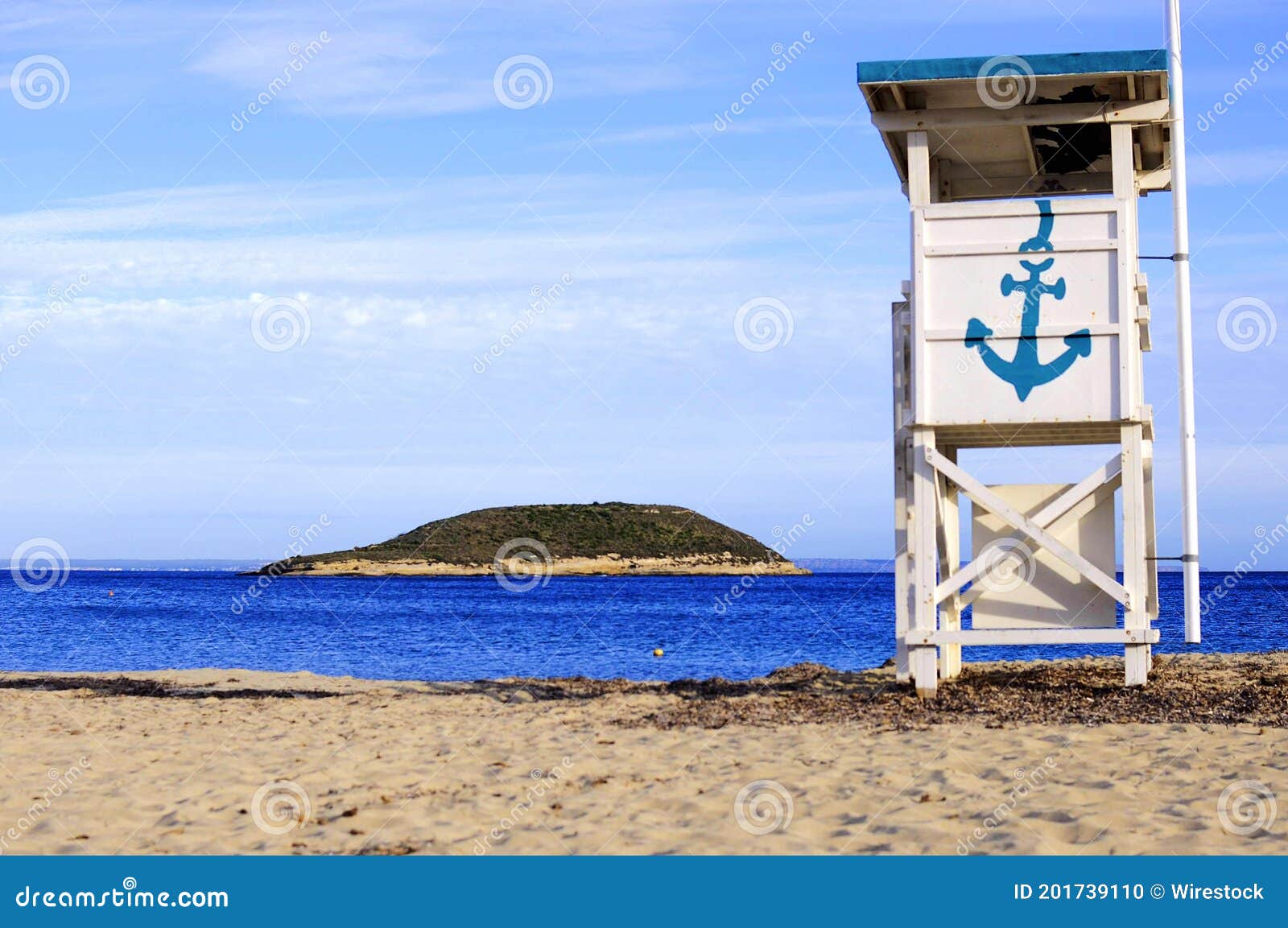 white lifeguard chair with a blue anchor on the isla de sa porrassa in mallorca