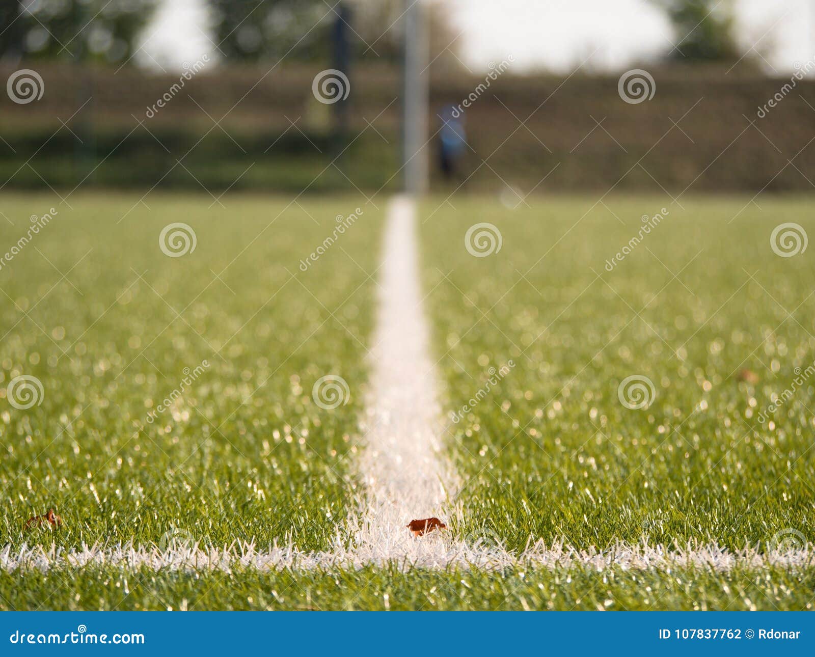 white line marks painted on artificial green turf background. playfield border.