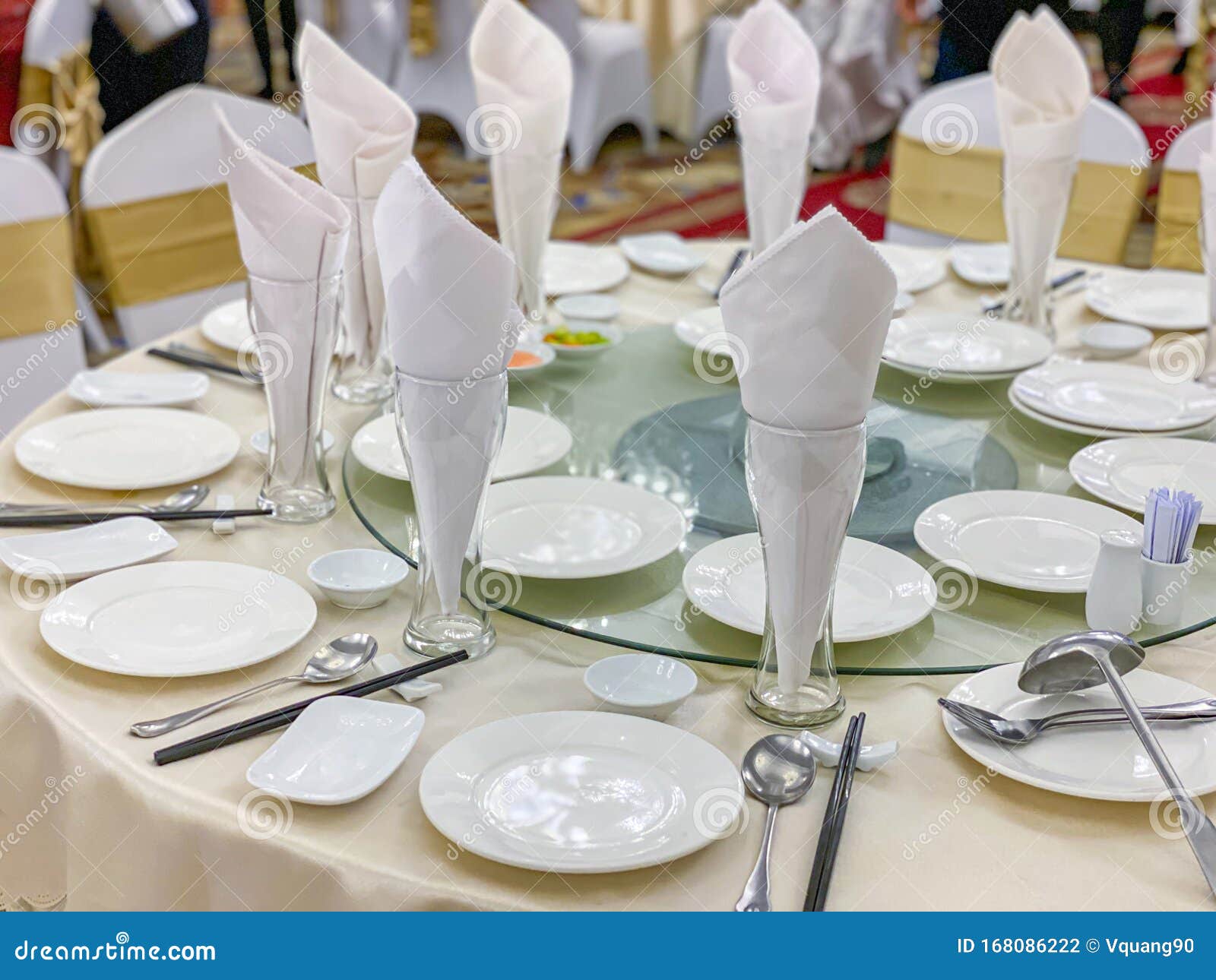 White Elegant Banquet Table Setup with Glasses and Ceramic Tableware