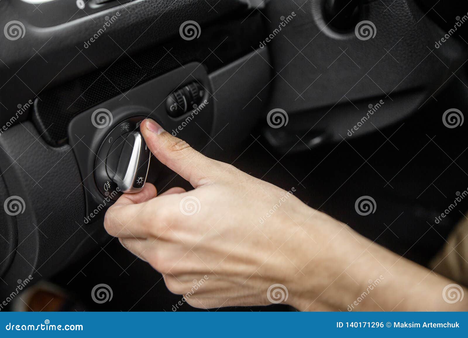 White Male Hand Toggles Headlight Switch Inside the Black Car Stock