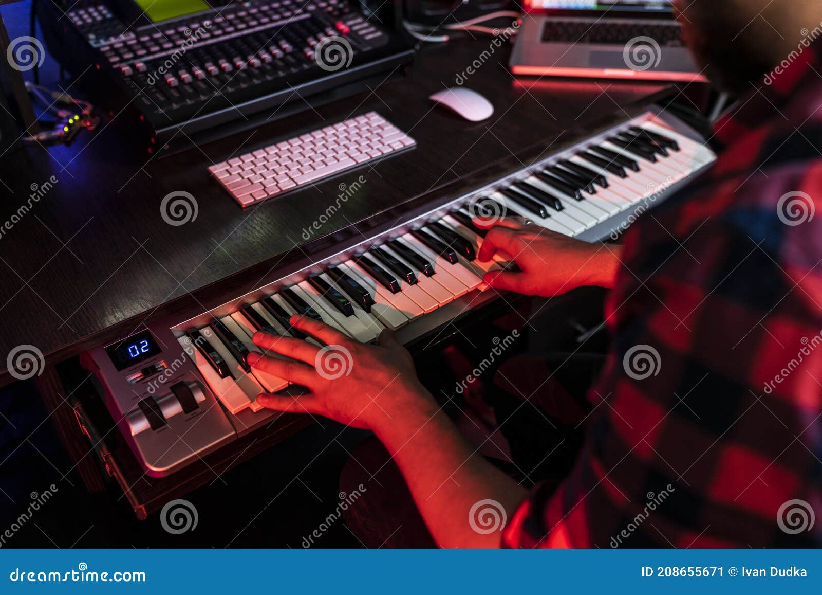 white man compositor is playing on keyboard in the record studio for radio fm