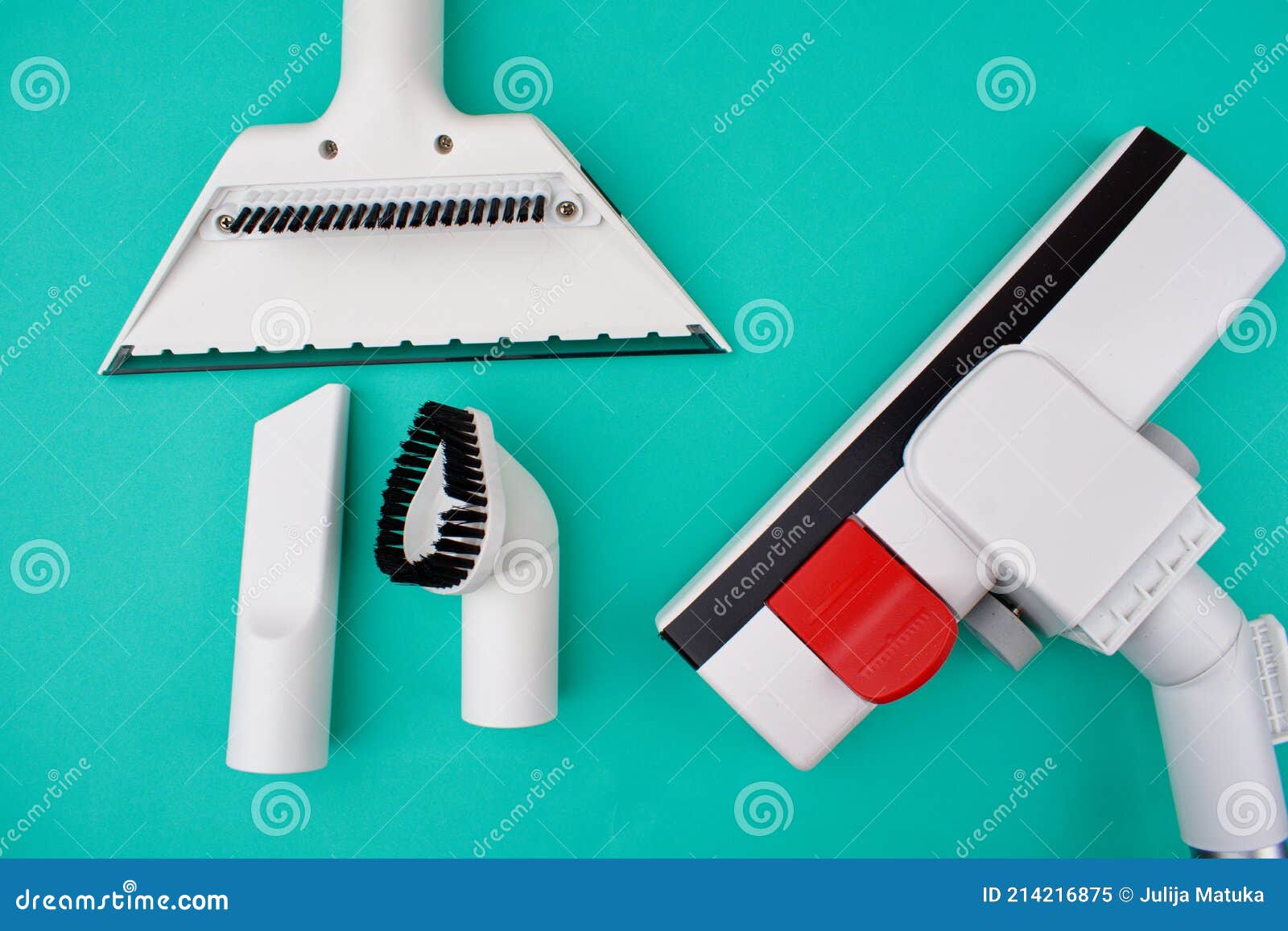 White Nozzles on an Ordinary Handheld Vacuum Cleaner on a Blue