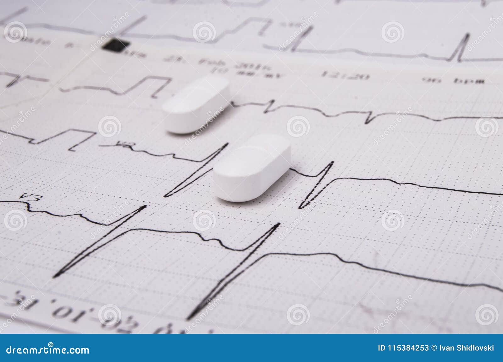 white oblong pills or tablets for treatment of diseases of the cardiovascular system as an option - statin lie on the paper elec