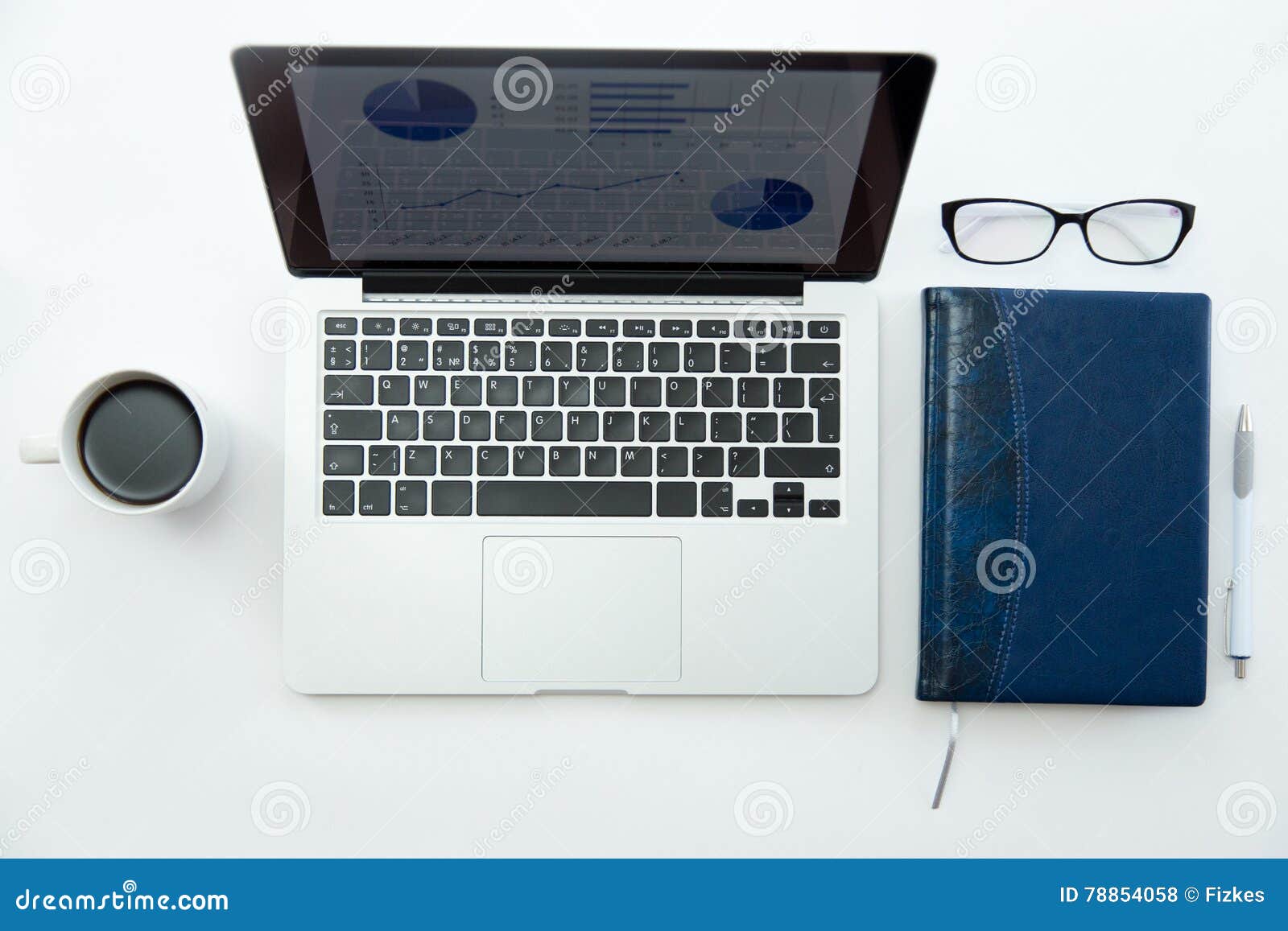 White Office Desk with Glasses, Laptop, Coffee and Notebook Stock Photo