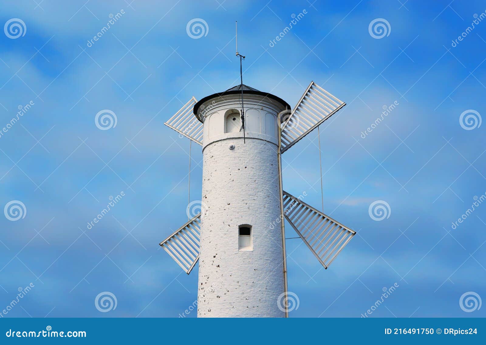 White Old Lighthouse Windmill with Blurred Background in Swinoujscie on the Baltic Sea in Poland Photo - of blue: 216491750