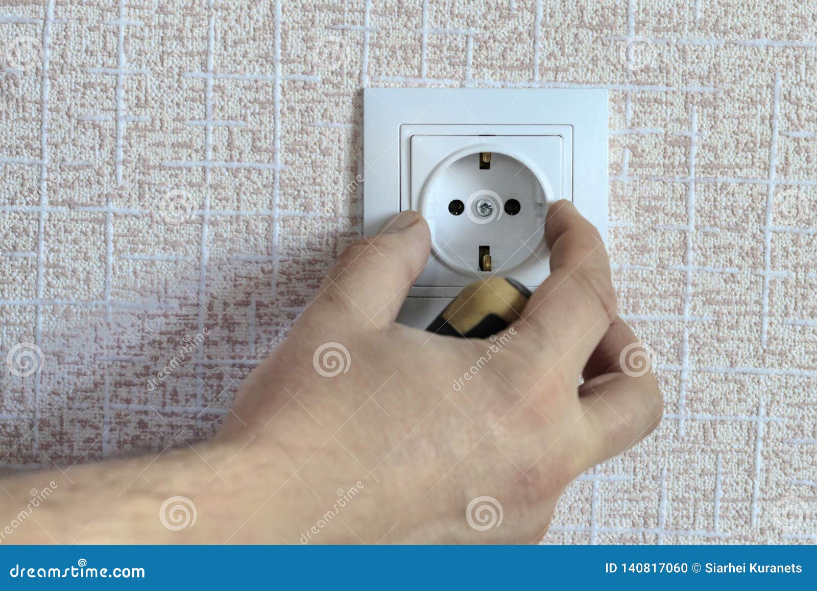 . White Outlet. the Wizard with a Screwdriver Sets it in Place Stock