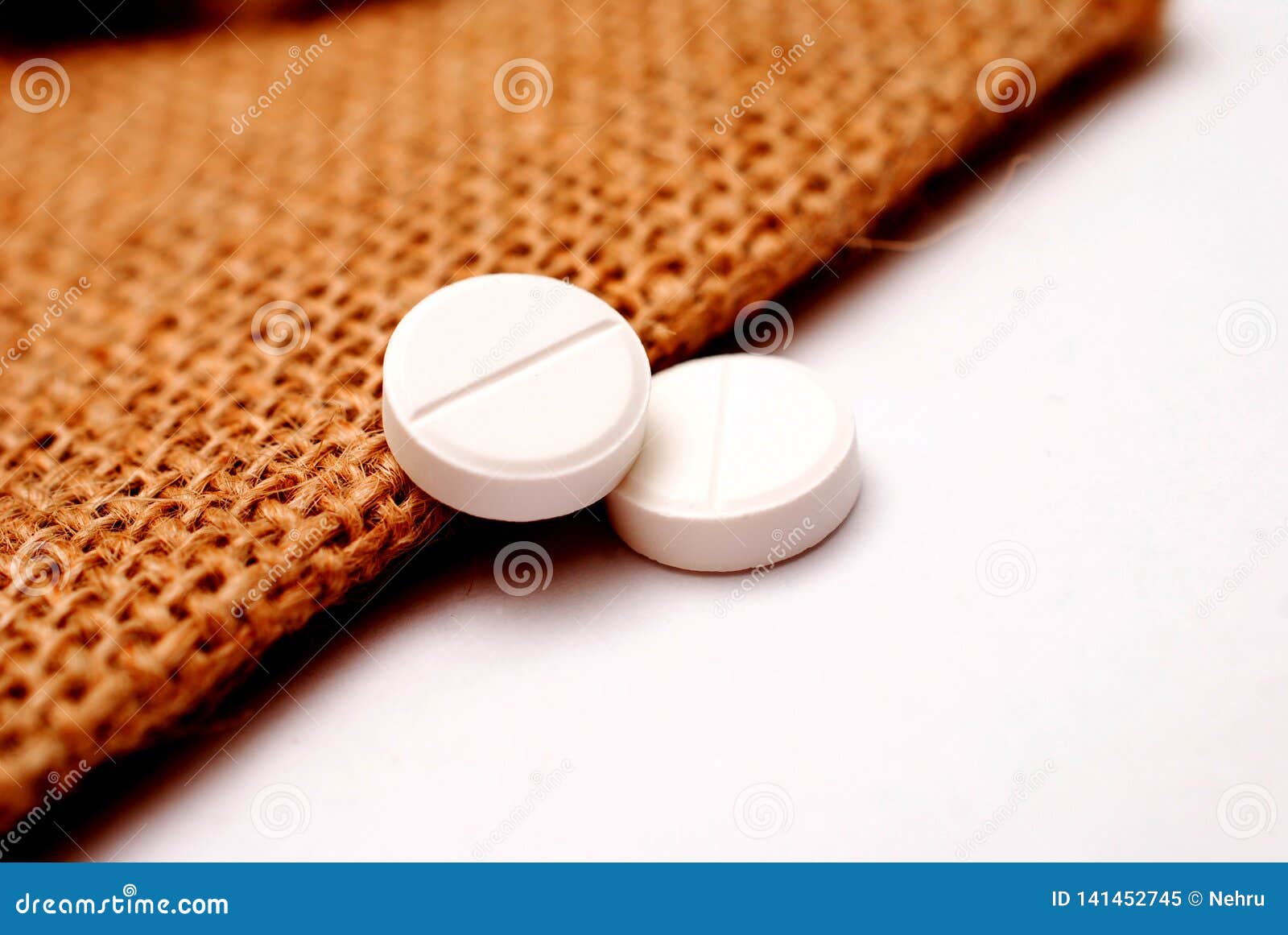 White Painkiller Pills On A Small Jute Bag Background Stock Image