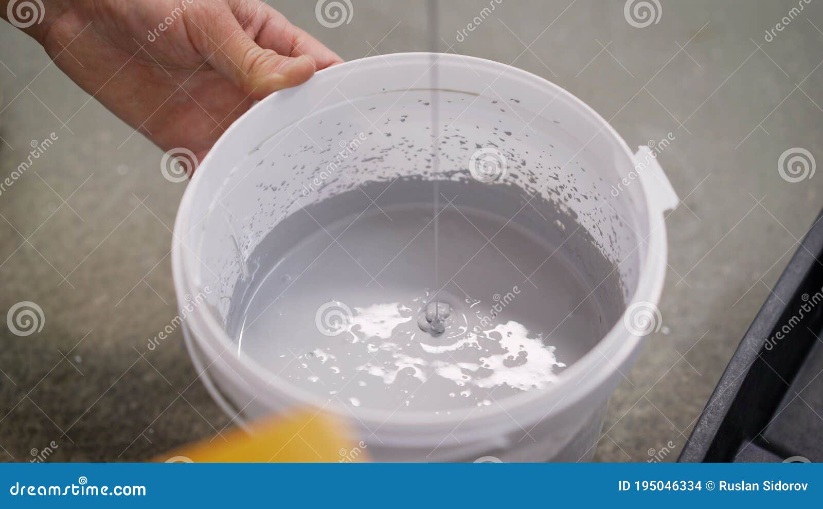 The White Paint is Mixed in a Bucket with a Drill. Drill Paddle Mixer
