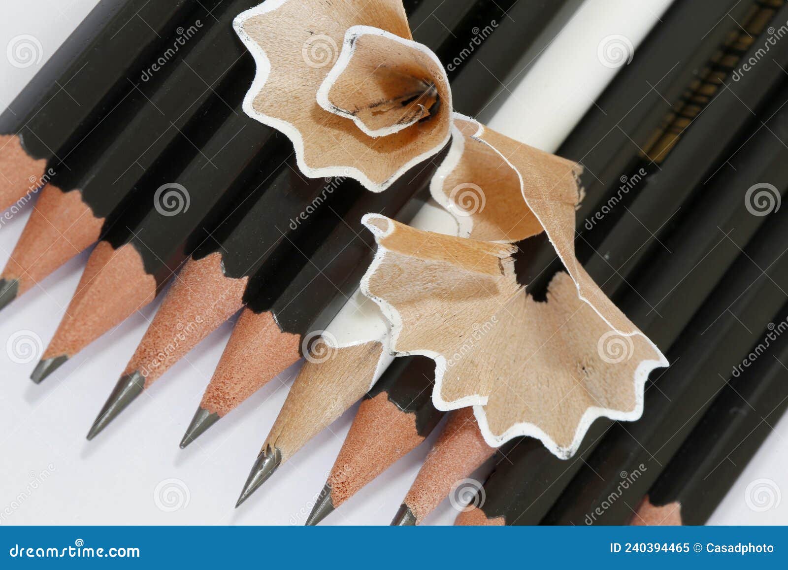 white pencil in a group of black pencils