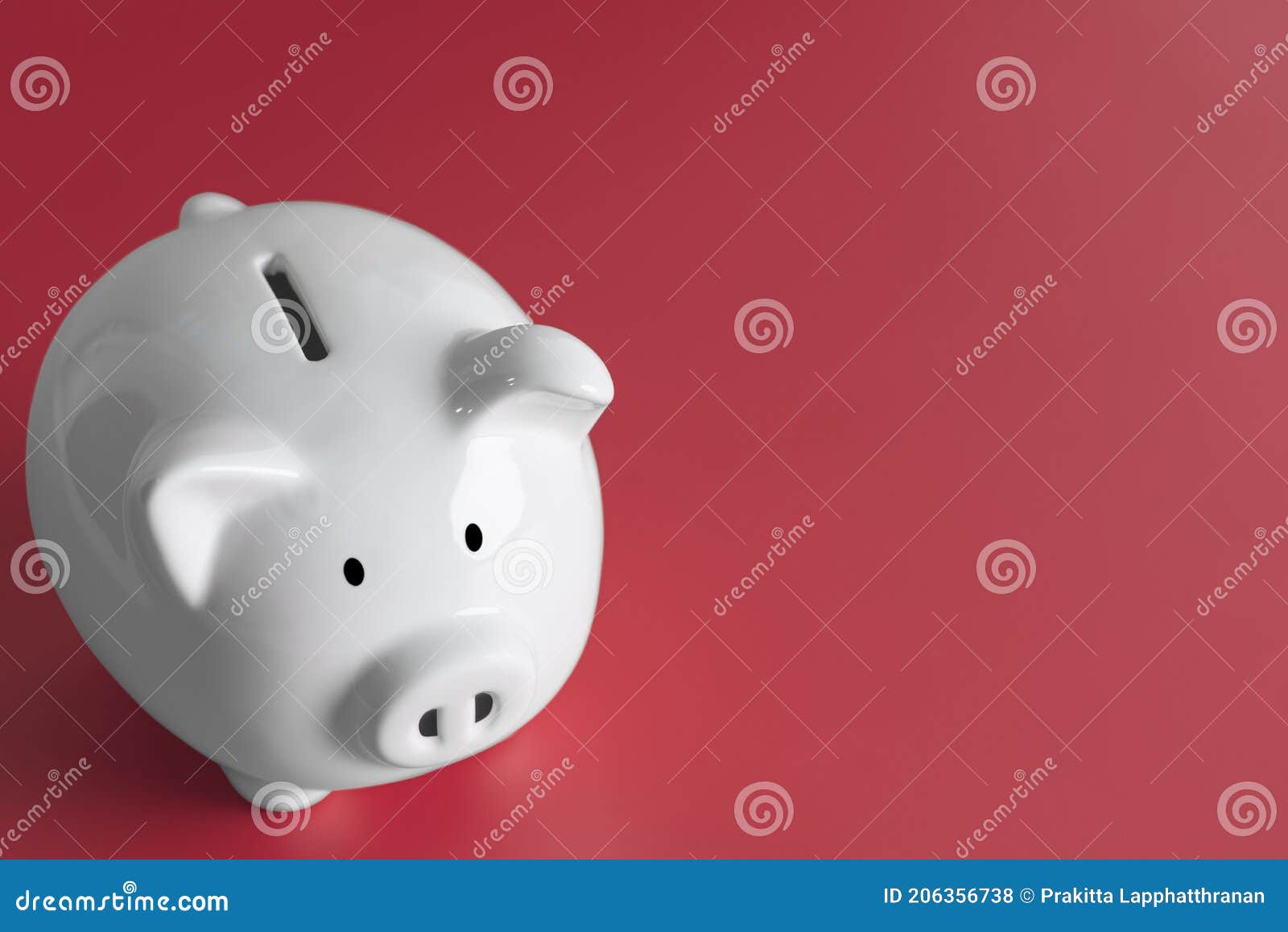 white piggy bank placed on the red background.