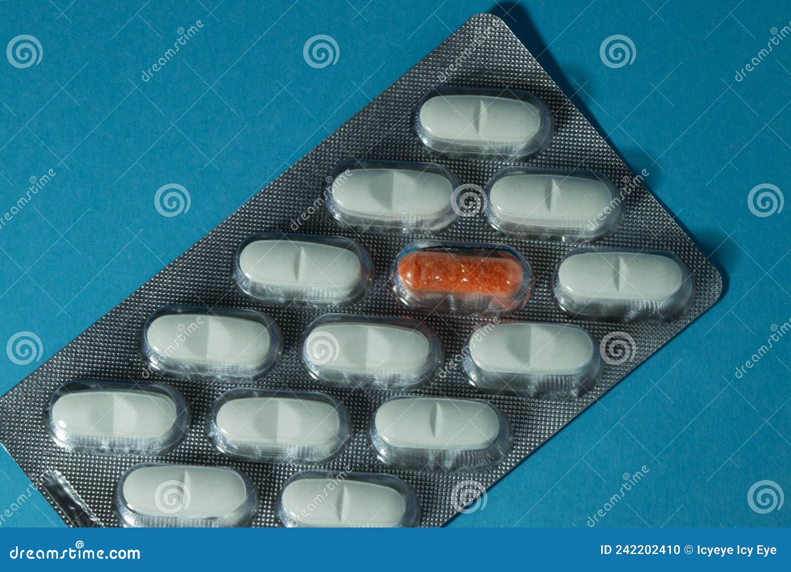 white pills and one orange pill on a blue background diversity highlight break the pattern creatively get out of the template