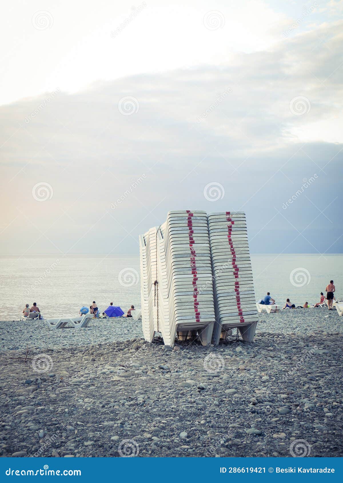 White plastic beach chairs stock image. Image of coastal 286619421