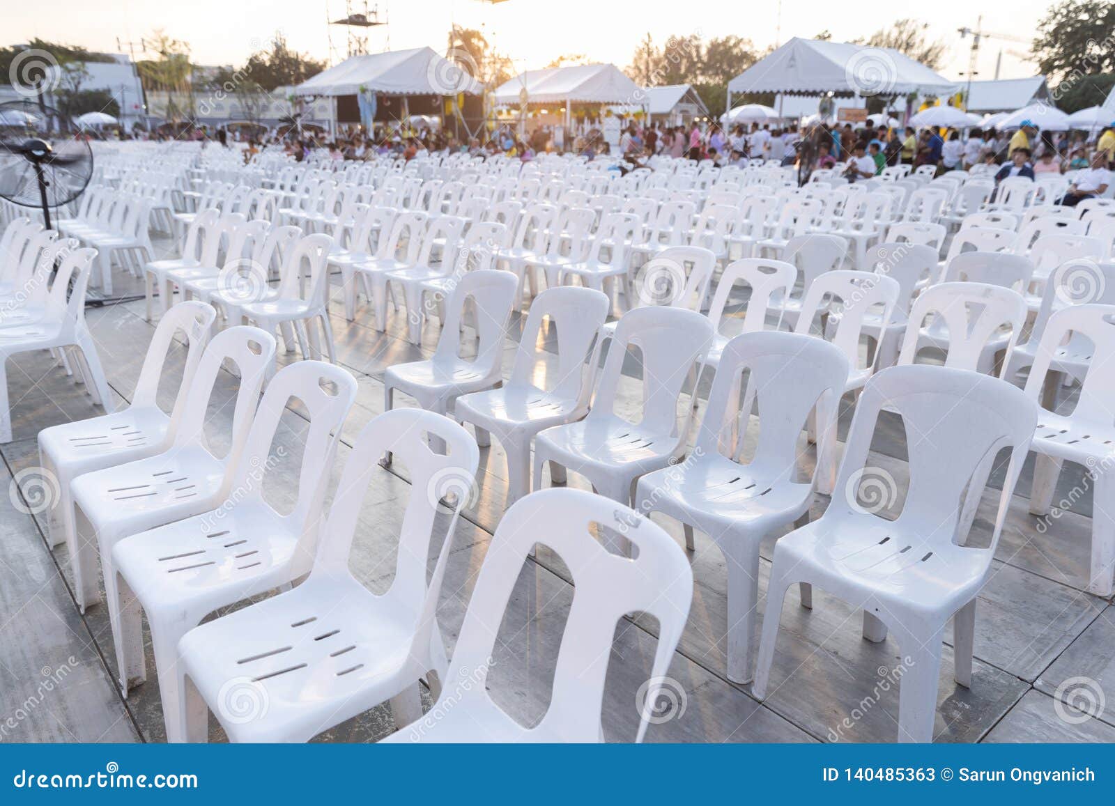 White Plastic Chairs in Rows Celebration and Outdoor Event with Light