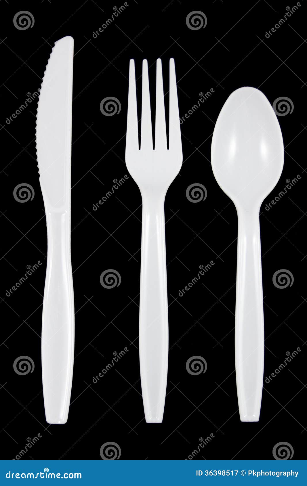 White Plastic Knife, Fork and Spoon on Black Background. Stock Image