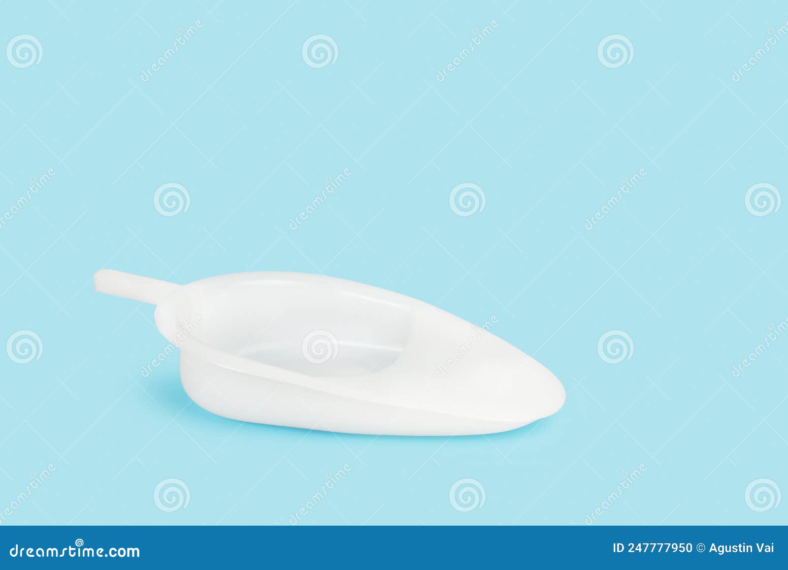 White Plastic Urinary Bedpan on a Light Blue Background Stock Photo