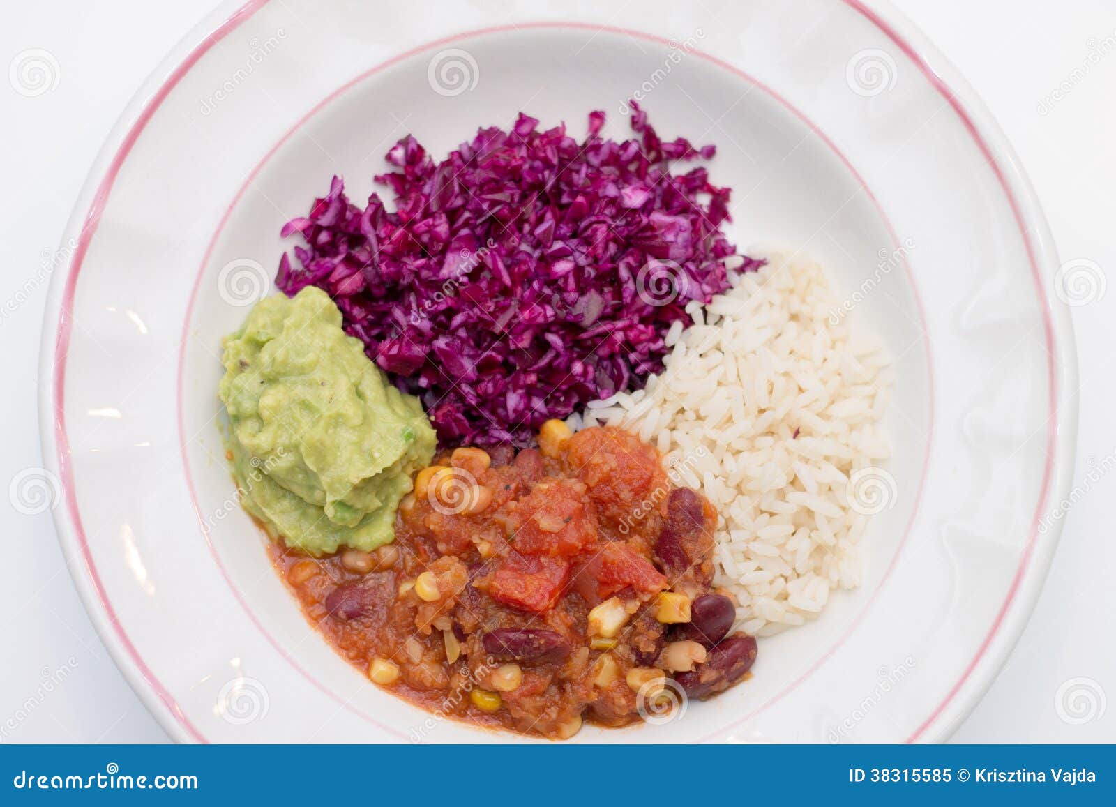white plate of chili sin carne with red cabbage, guacamole and r