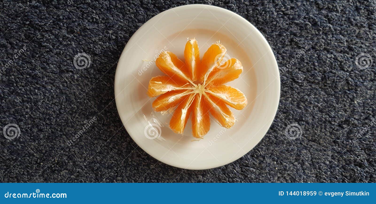 White Plate with Peeled Mandarin Slices Stand on Dark Surface Stock