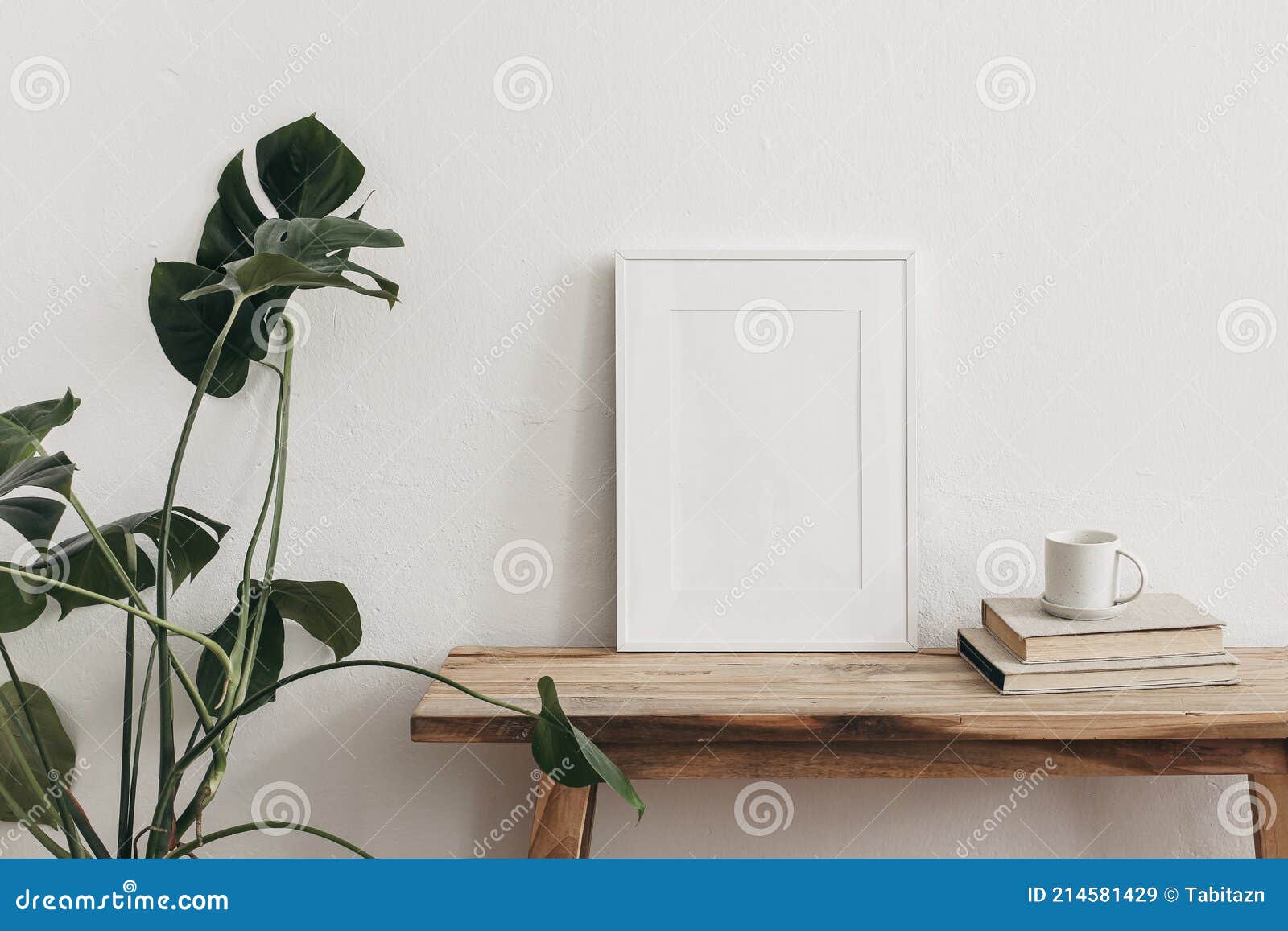 white portrait frame mockups on vintage bench, table. cup of coffee on pile of books and monstera potted plant. white