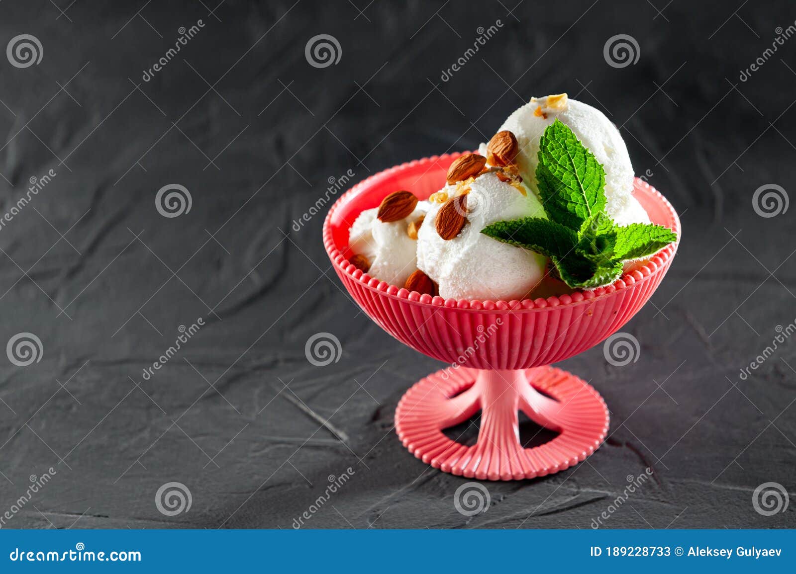 white prombir ice cream in pink peel with mint leaves and cocoa on a gray background with an empty space for inscription