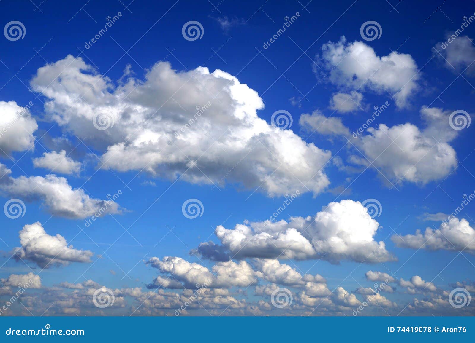 white puffy clouds in blue sky