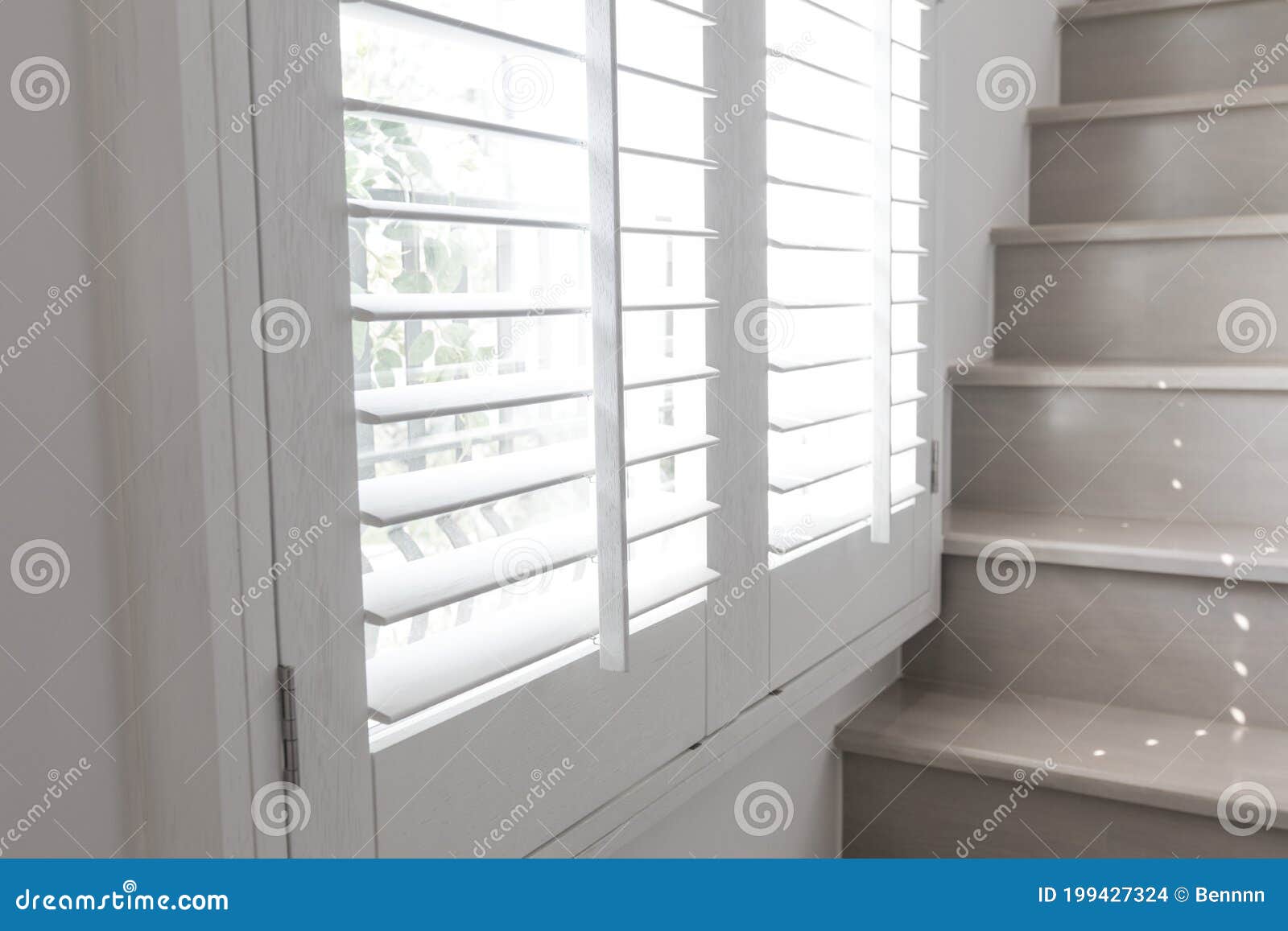 White Roller Blinds or Louver Curtains at the Glass Window Stock Photo