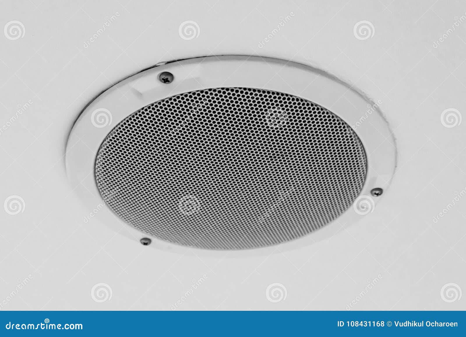 White Round Circle Speaker and Grille Hanging on Ceiling Stock Photo