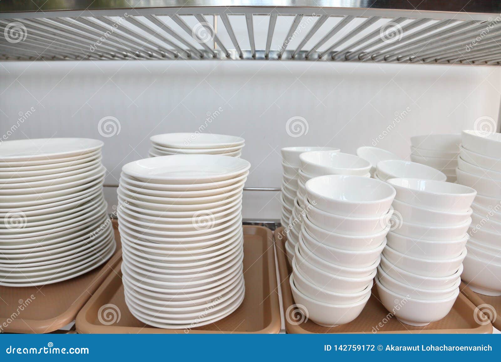 White Set of Ceramic Including Plate, Dish, Cup Stacking Up the Rack
