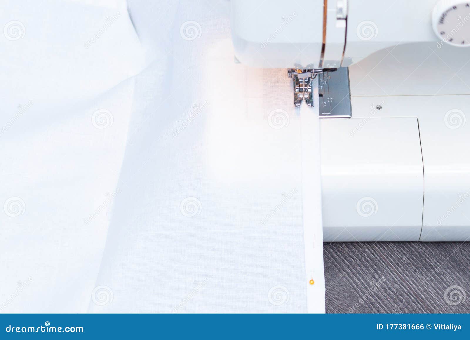 White Sewing Machine with White Cotton Fabric, Closeup Stock Photo