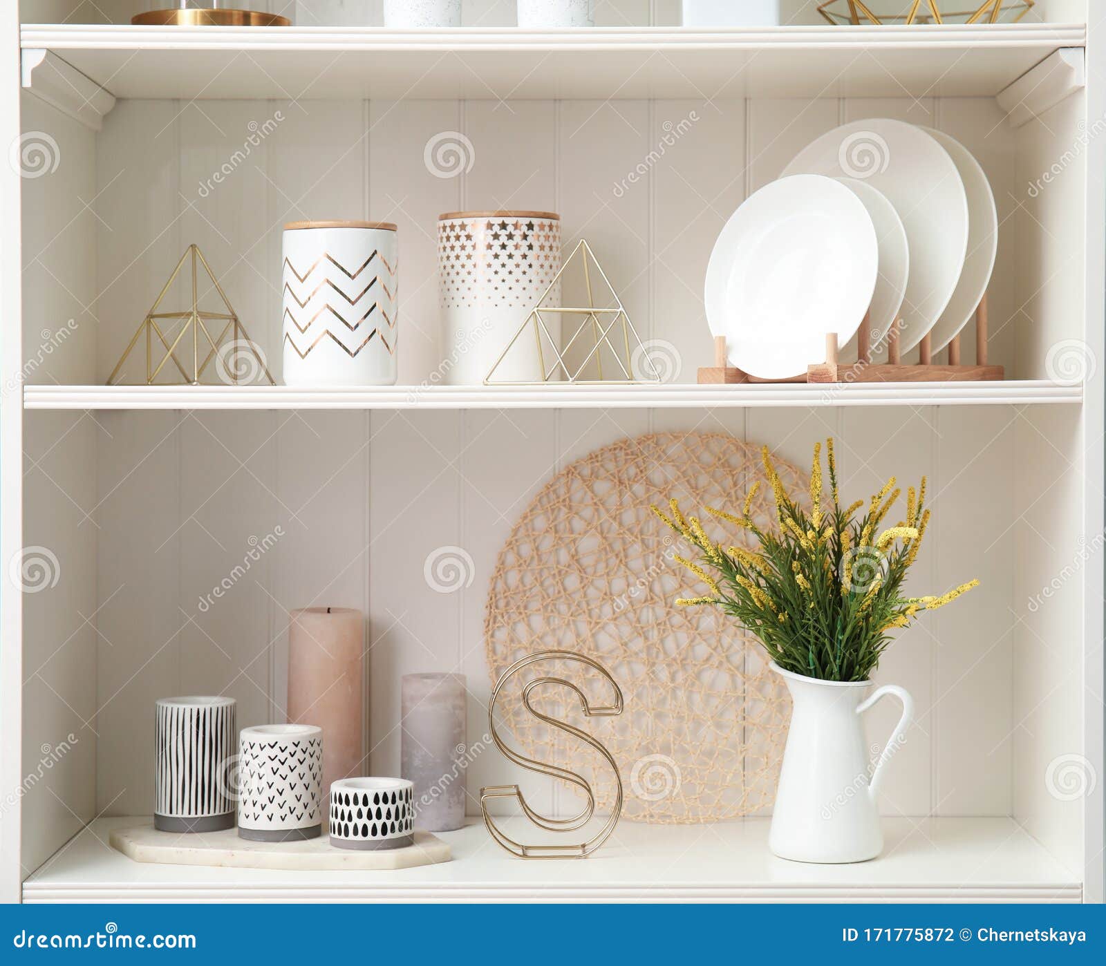 White Shelving Unit with Dishes and Decorative Stuff Stock Photo
