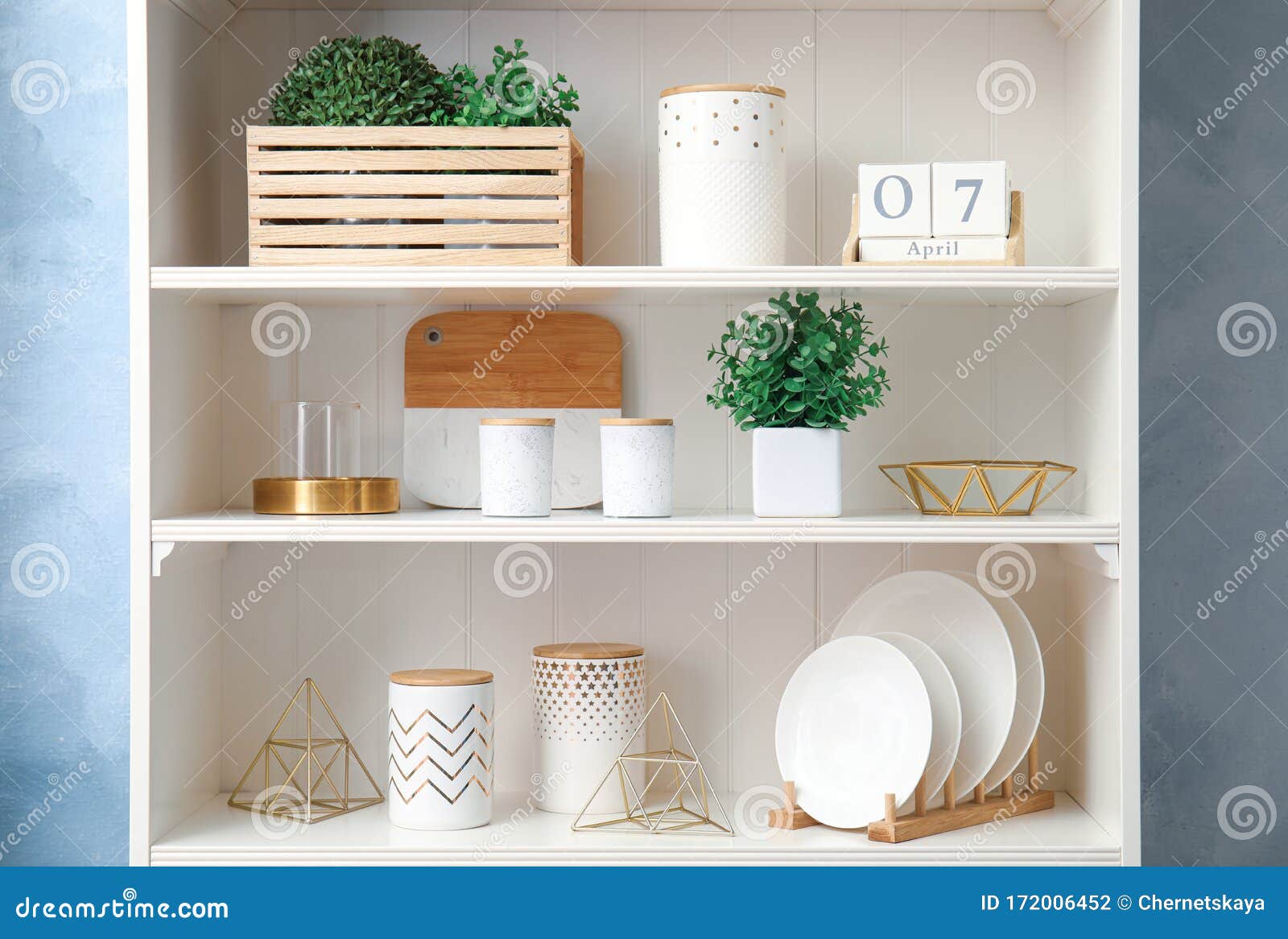 White Shelving Unit with Dishes and Decorative Stuff Stock Photo