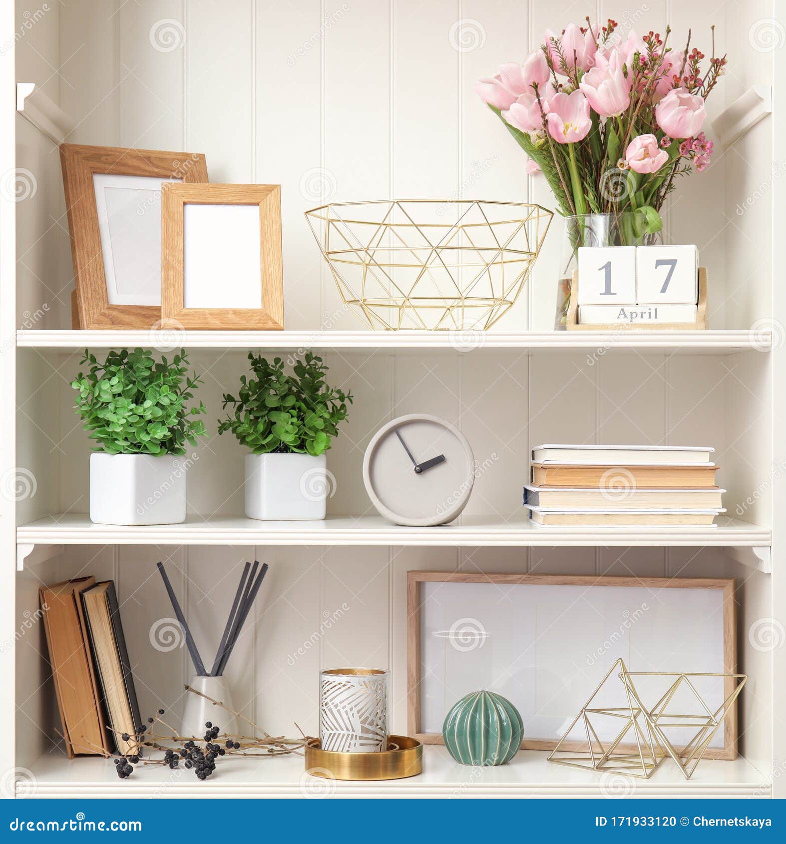 White Shelving Unit with Plants and Decorative Stuff Stock Photo