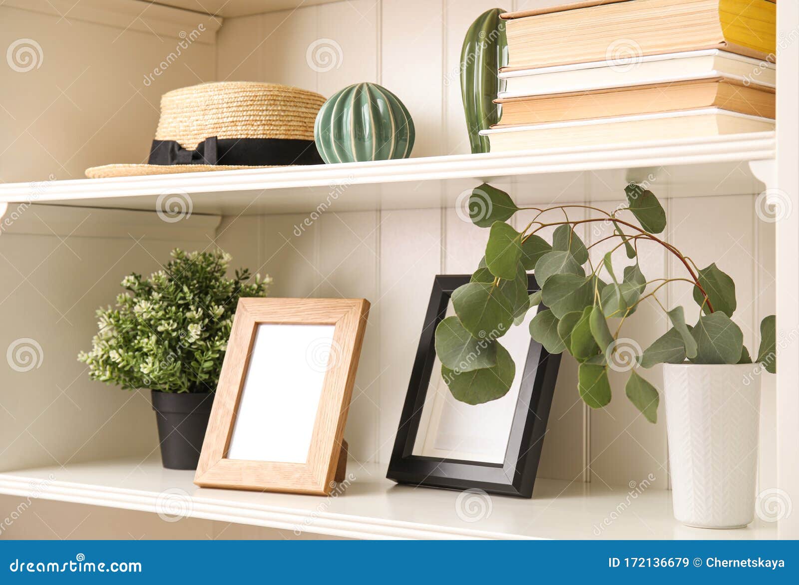 White Shelving Unit with Plants and Decorative Stuff Stock Image