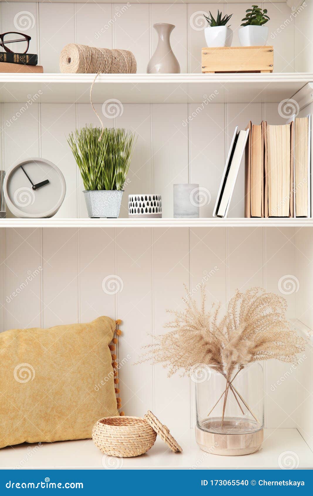 White Shelving Unit with Plants and Decorative Stuff Stock Photo