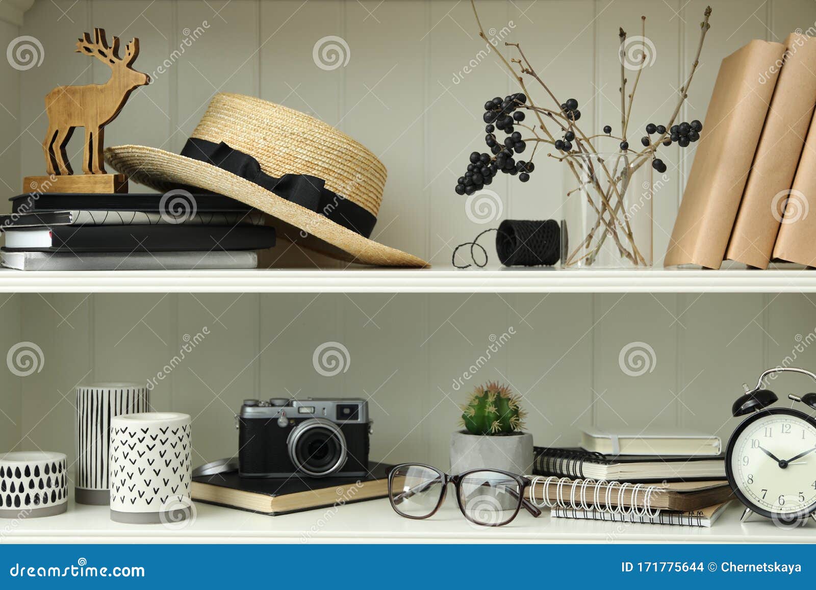 White Shelving Unit with Straw Hat and Decorative Elements Stock Photo