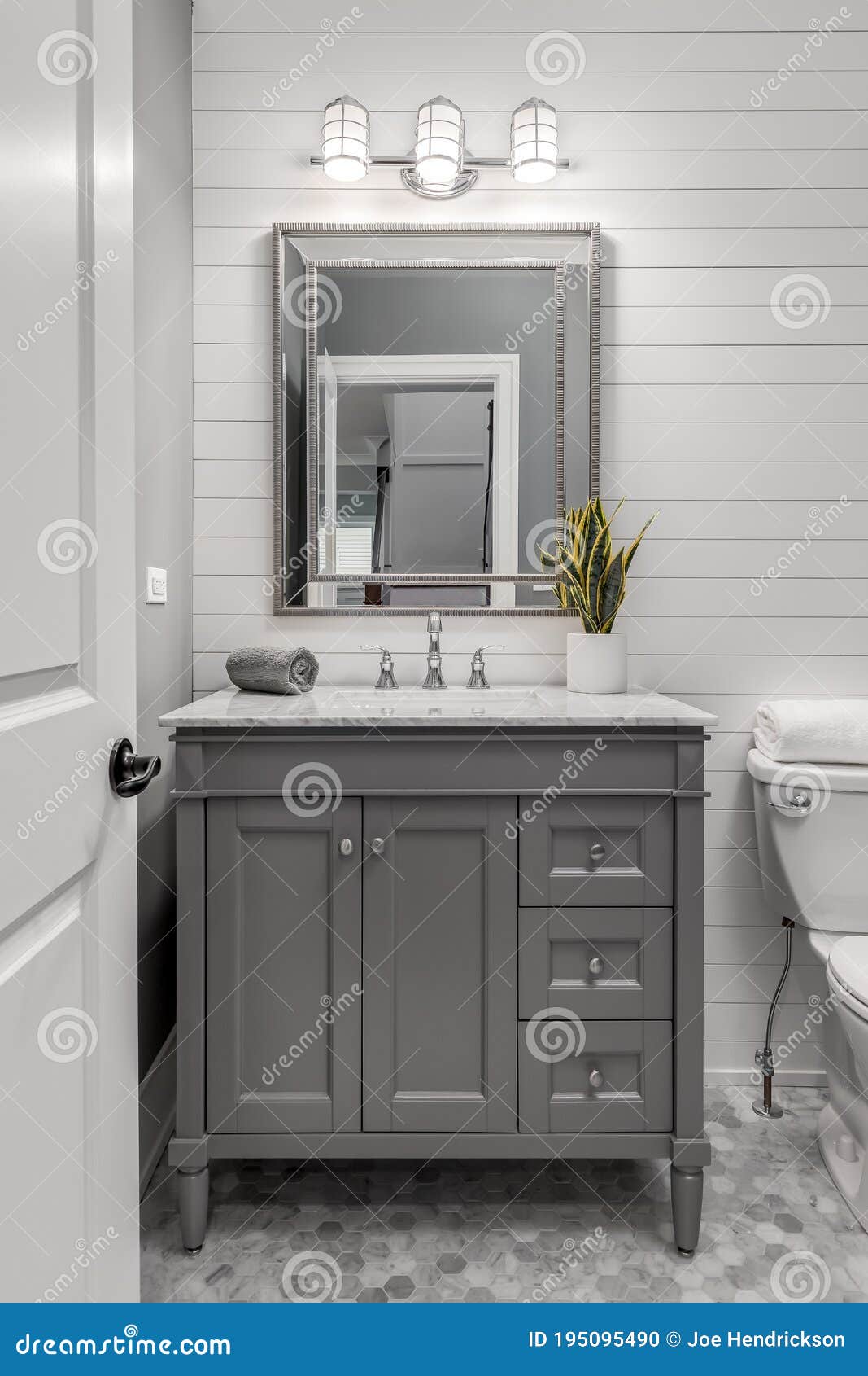 white shiplap bathroom with a grey vanity.