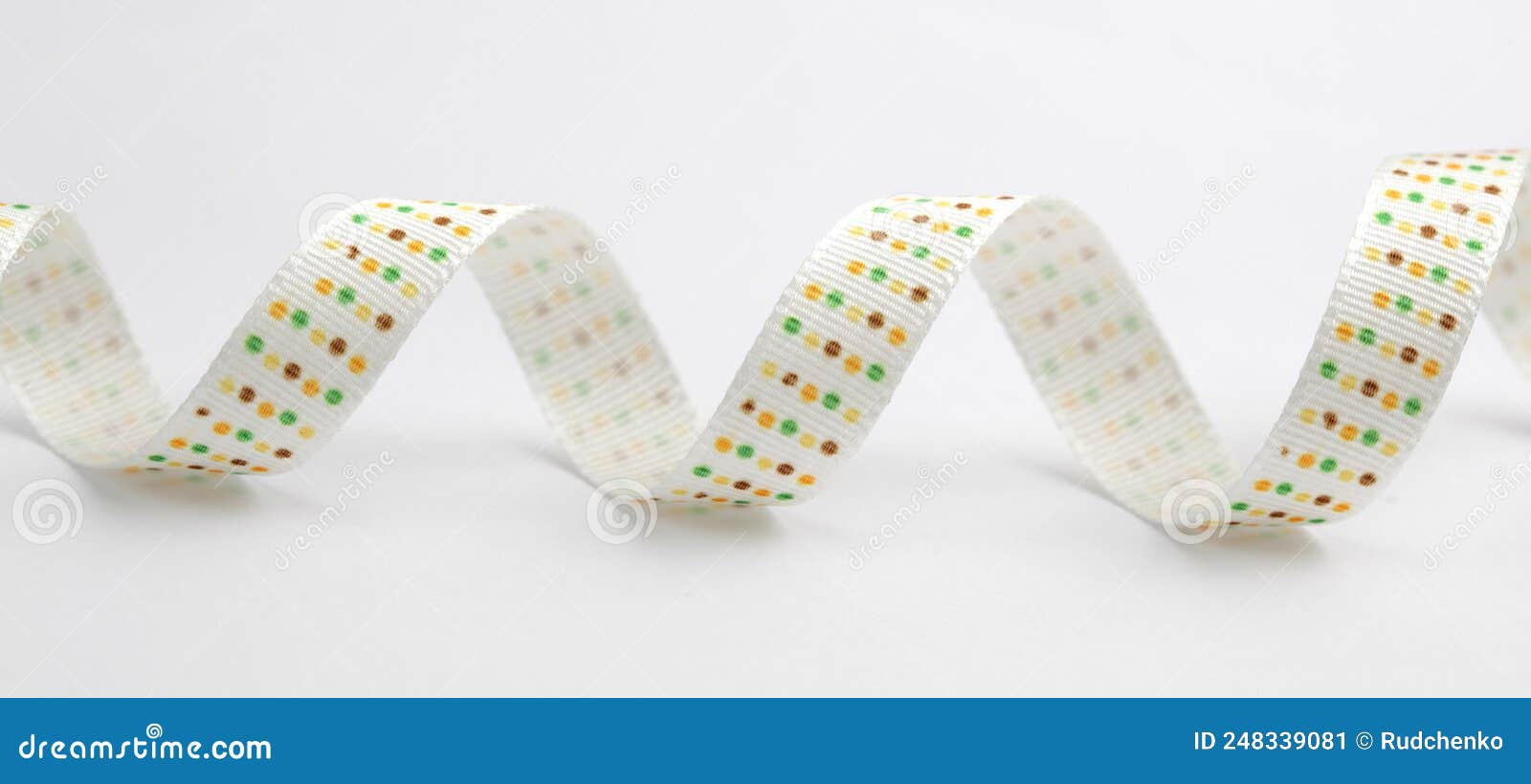 White Silk Ribbon with Color Dots on White Background Stock Image